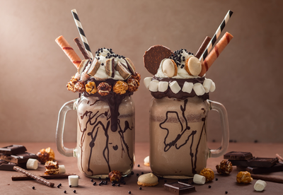 Crazy milkshakes loaded with lots of toppings in mason jars