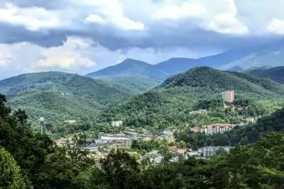 a view of distant Gatlinburg TN surrounded by the Smoky Mountains