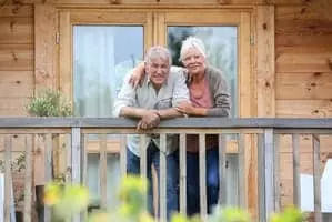 older couple on the deck of a cabin