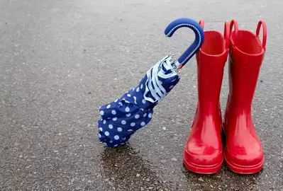 Red rain boots and a blue polka dot umbrella