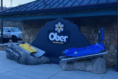 Ober Mountain sign with mountain coaster and alpine slide carts