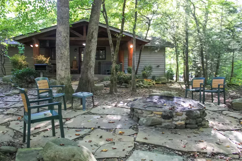 Creekside cabin exterior and fire pit